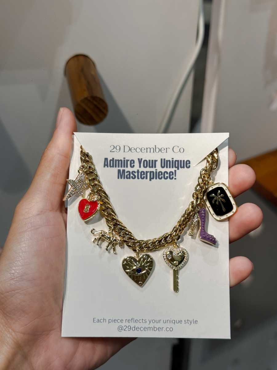 Guests creating jewelry at charm bar