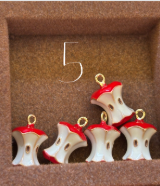 A bitten apple charm